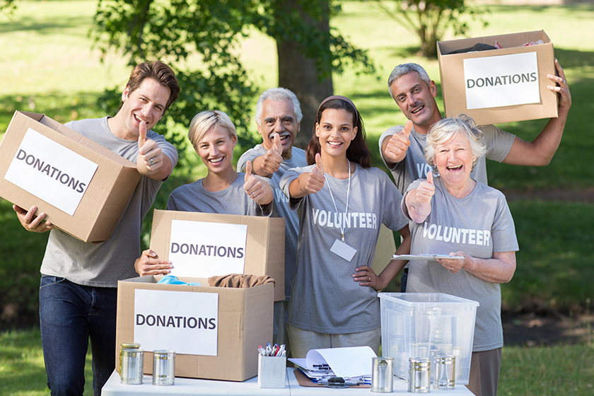 Happy volunteer family with thumbs up 