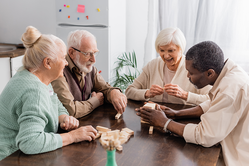 Excited senior woman smiling while playing 