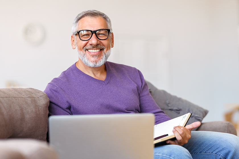 Handsome happy senior man in glasses