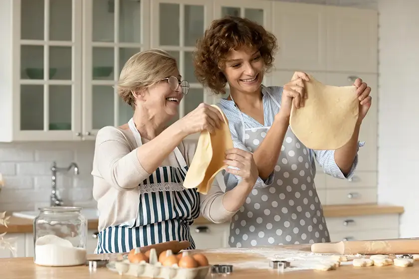 happy-young-woman-with-mature-mother-cooking-1